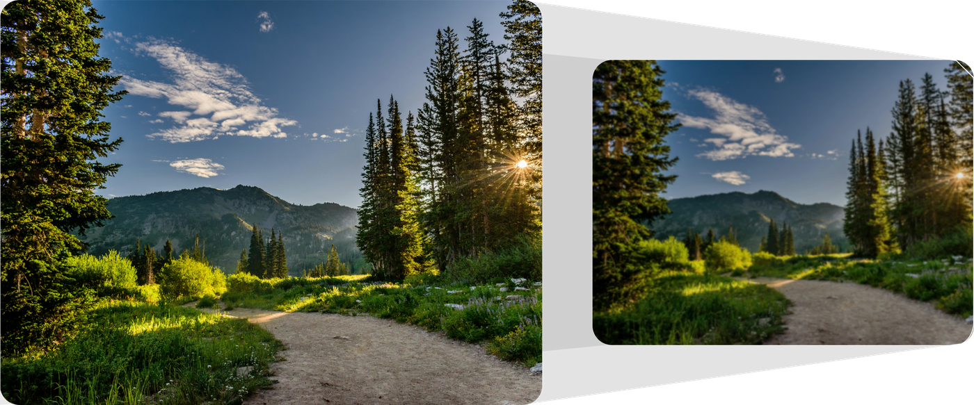 Scenic view of a forest path with mountains in the background, framed by a white border.