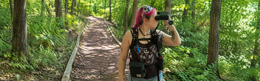 Solvia 8x32 story featuring Natalie Farley using the binoculars on a wooded trail.